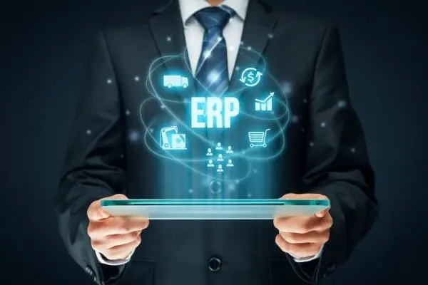 Man on suit holding tablet device generating ERP hologram